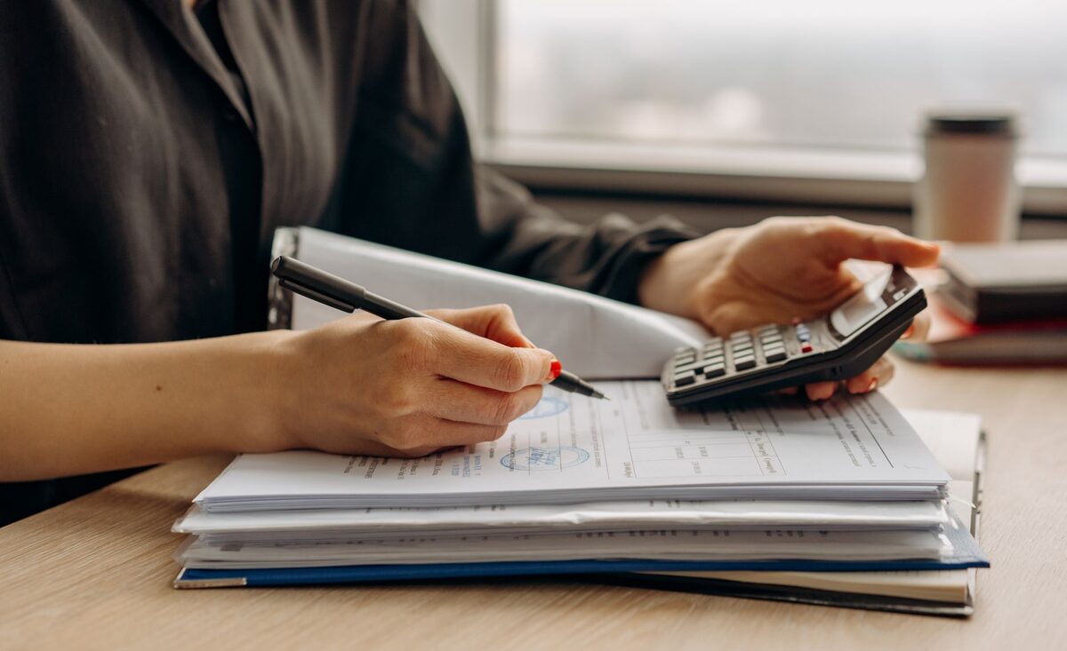 Working through a client's financial documents with a calculator